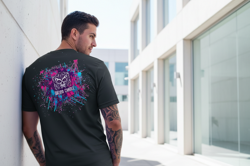 Man wearing a black t-shirt with colorful graphics on the back, standing in front of modern architectural elements.